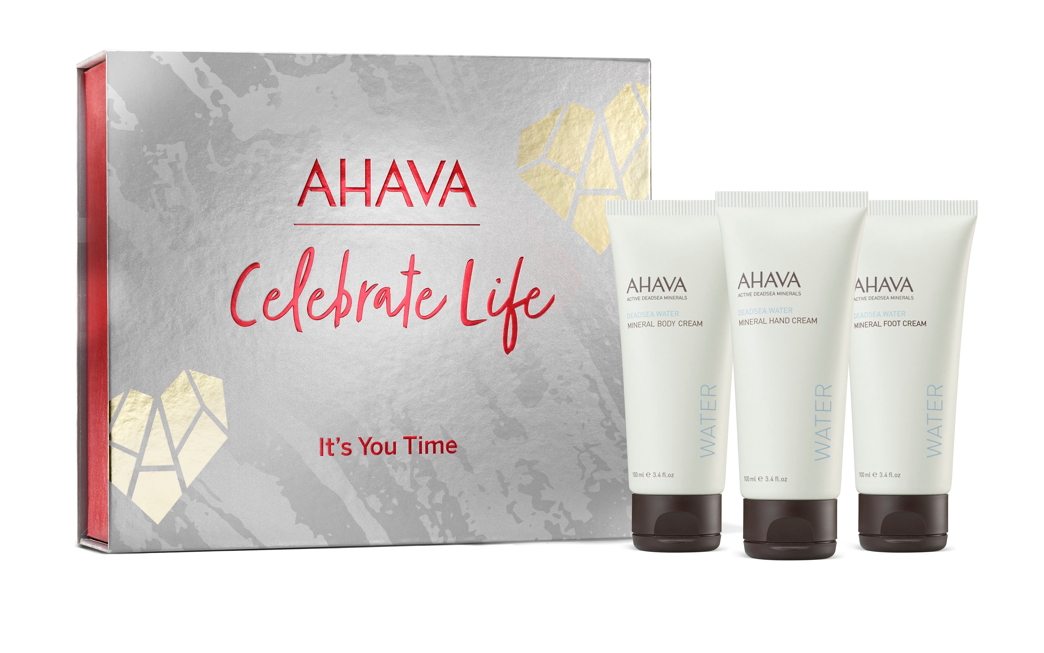 AHAVA Geschenkset mit drei Mineralcremes vor einer grauen Box mit rotem Text 'Celebrate Life'.