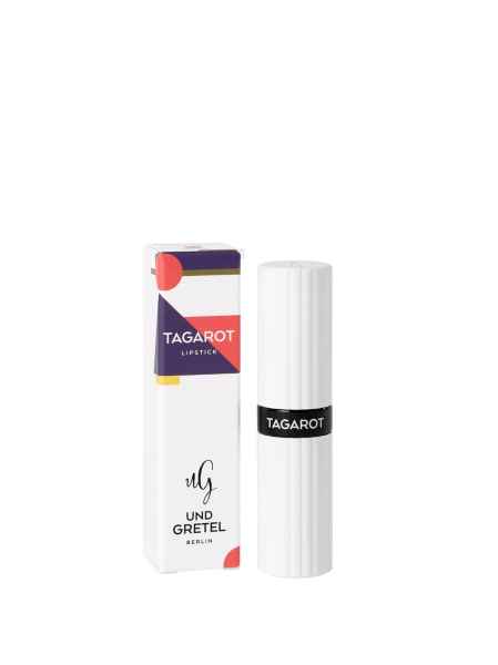 Tagarot Lippenstift von Und Gretel Berlin, weiße Verpackung mit schwarzem Etikett und bunter Schachtel im Hintergrund.